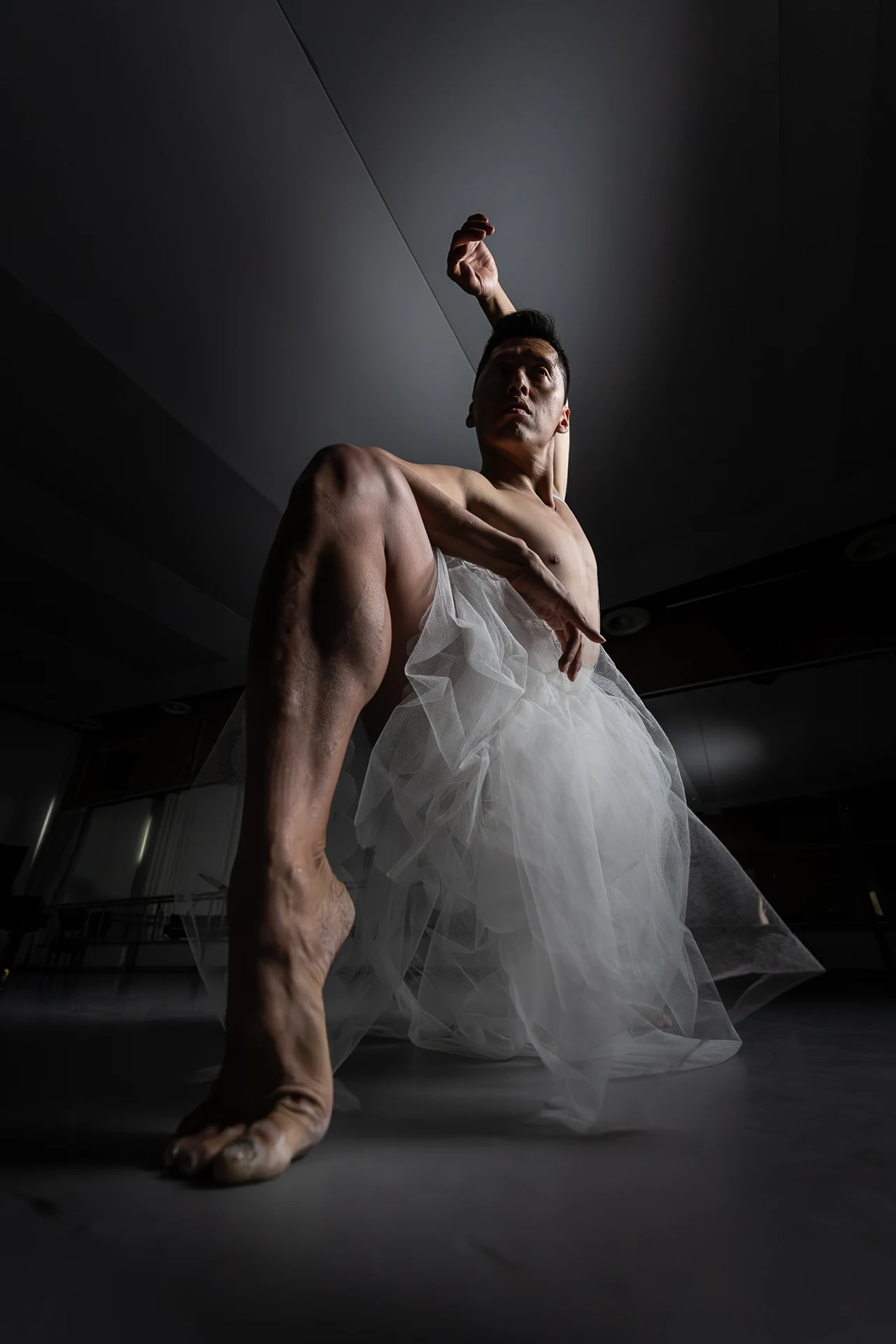 Seated dancer raising one arm