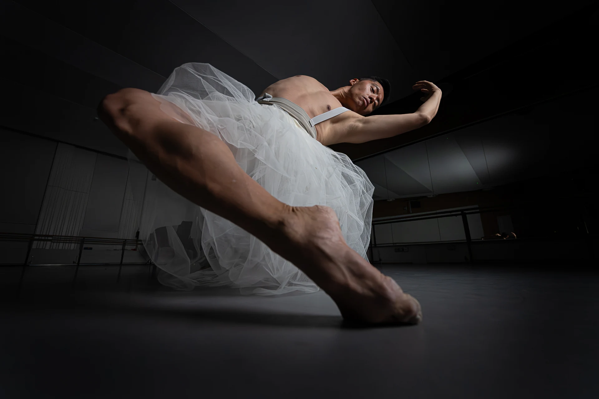 Dancer reclining in white tulle, photographed from below