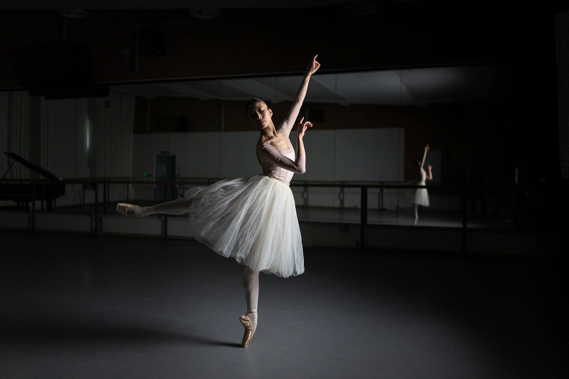 Dancer reaching upwards with arms extended