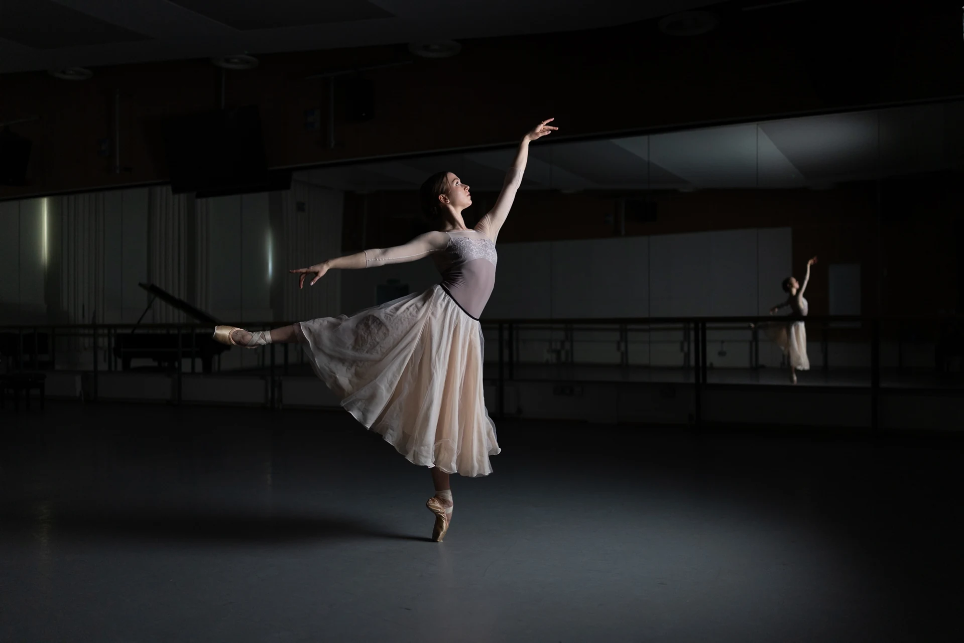 Dancer leaping across the studio