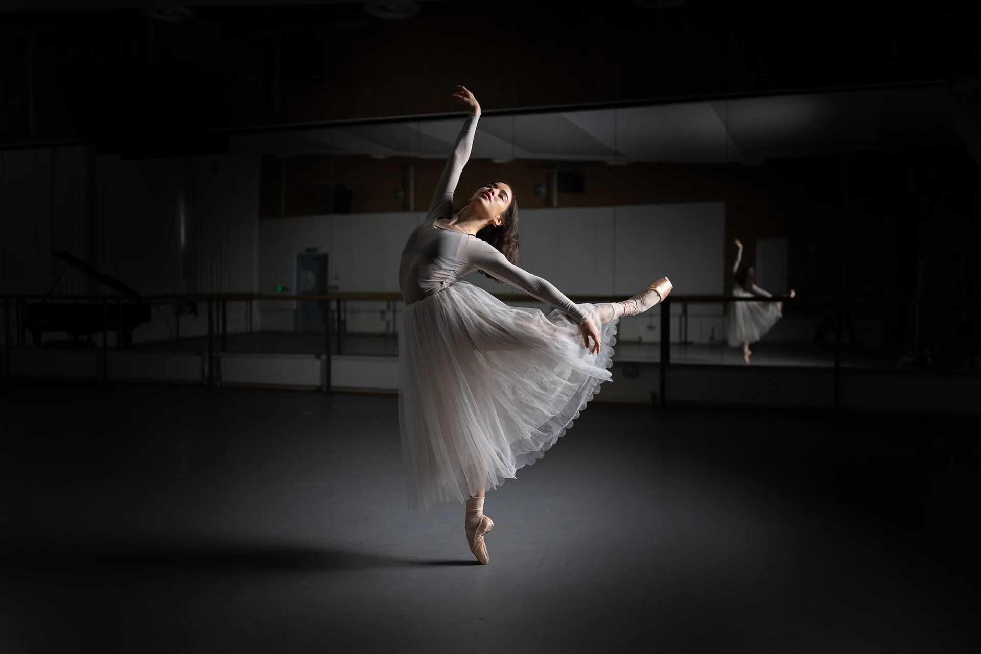 Dancer holding white tulle while balancing