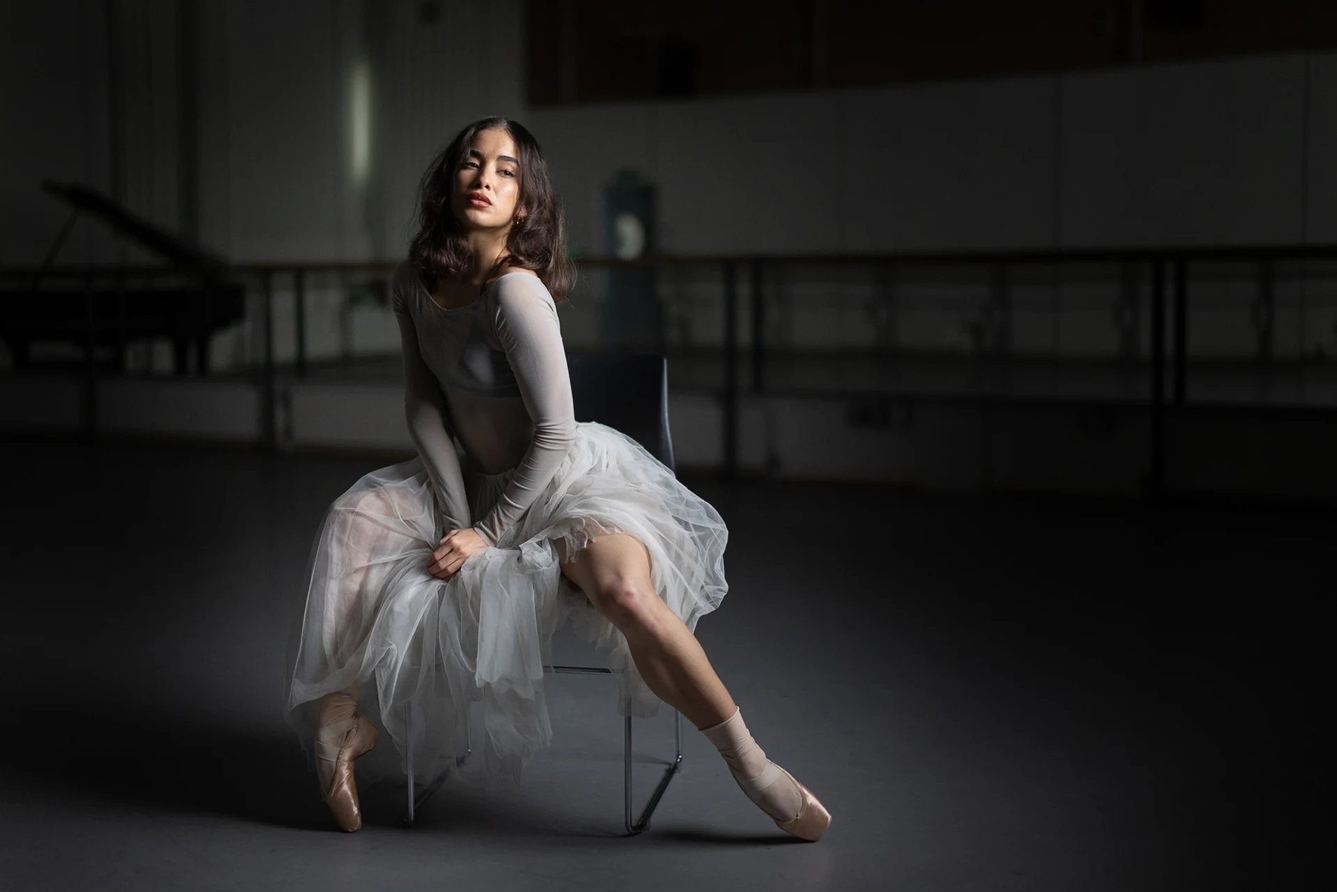 Seated dancer looking towards the light
